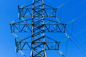 High voltage towers with blue sky background.