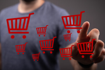 Person interacting with shopping carts, online shopping and e-commerce concepts for marketing, sales, and digital retail platforms.
