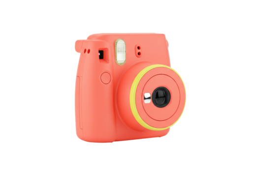 Isolated coral camera in studio, vintage look, modern instant photography gadget for hobbies