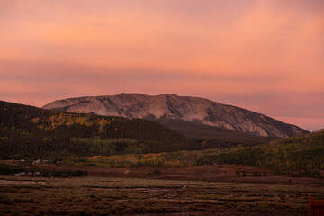 Beautiful orange clouds over a mountain landscape at sunrise in Crested Butte, Colorado