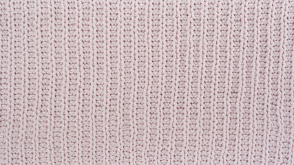 Sweater or scarf fabric texture large knitting. Knitted jersey background with a relief pattern. Wool hand- machine, handmade.