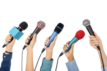 A group of hands, diverse in appearance, holds several colorful microphones, raised and ready for a press conference or public communication event.
