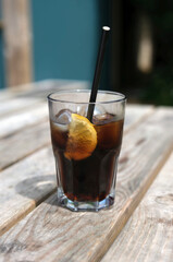 Glass of cola with ice and a slice