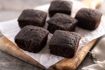 Homemade chocolate brownies with sugar powder on wooden table	