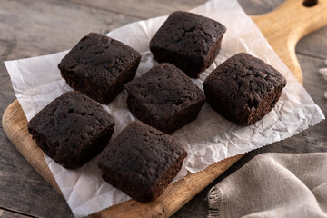 Homemade chocolate brownies with sugar powder on wooden table	