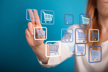Person interacting with digital shopping cart icons, symbolizing online shopping, e-commerce, and digital transactions.