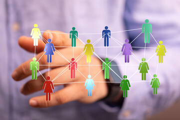 Image of interconnected people symbols in various colors, symbolizing community, networking, teamwork, and global connection within a business o