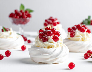 Delicious xmas food arrangement featuring meringues topped with festive berries against a snowy backdrop
