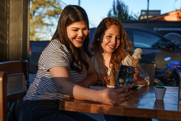 Happy young women enjoying friends moment taking selfie