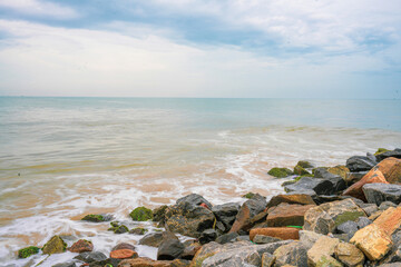 A rocky shoreline with a calm ocean in the background