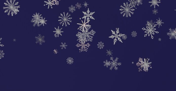Abstract winter scene of falling snowflakes against a deep blue background, perfect for holiday greetings and winter themes.