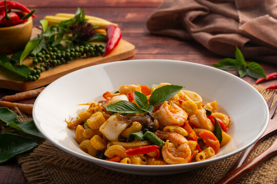Spicy Stir Fried pasta seafood,Thai Spicy stir fried macaroni with shrimp and squid with chilli garlic green peppercorn Fingerroot and kaffir lime leaves (Pad Cha).Thai fusion food.