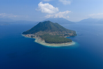 Afternoon light shines on the volcanic island of South Ternate in the middle of Pantar Strait, near Alor, Indonesia. This region of the Lesser Sunda Islands harbors incredible marine biodiversity.