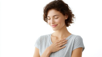 Young woman smiling gently, hands placed on chest, showing gratitude, wearing casual t-shirt, isolated on white background