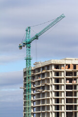 High-rise residential building construction site, urban development project, multiple tower cranes working on concrete frame structure, real estate investment, industrial architecture