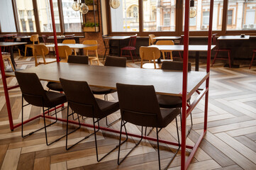 Modern restaurant, Interior of a modern urban restaurant. A cafe in warm colors with large windows