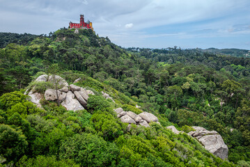National Palace of Pena perched atop a hill in Sintra, Portugal, as seen from the Moorish Castle hill