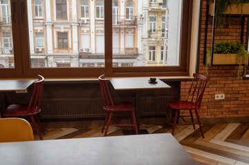 A cozy restaurant interior with tables for a quick lunch, large windows overlooking the old town