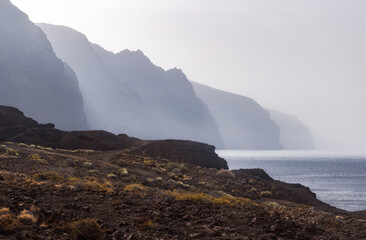 Exploring the Majestic Cliffs of the Giants in Tenerife, Spain Under Soft Mist