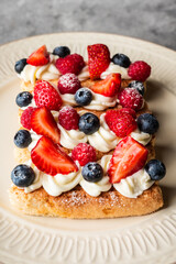 Tiramisu-style dessert with savoiardi, cream cheese and berries. Sweets and desserts.