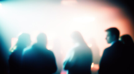 Abstract shot with bokeh effect, where human figures are barely discernible in the glow of spotlights. Emphasizes a sense of anonymity and crowd energy