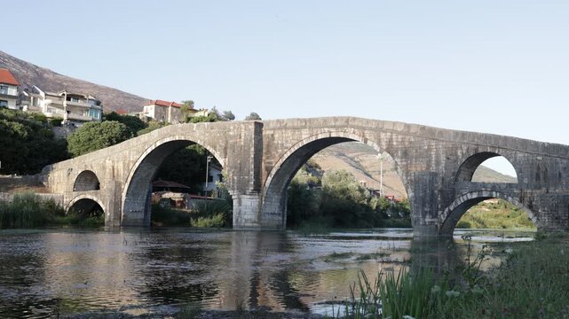 View of the stone arch bridge over the river. Perovic Bridge or Arslanagic Bridge in Bosnia and Herzegovina. High-quality 4k footage