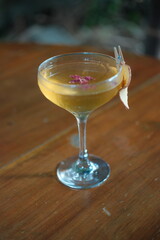 Elegant cocktail with apple garnish and rose petals, perfect for celebratory events and luxury lifestyle branding