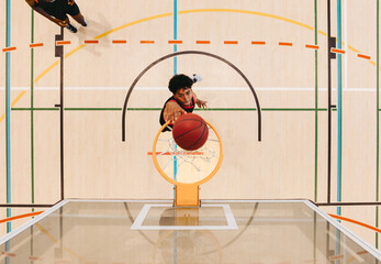 Top view of a basketball player making a shot on an indoor court