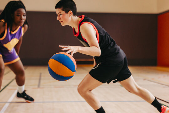 Confidence in motion: Female athlete sprints toward the hoop