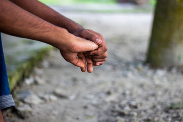 Closeup of hands clasped together, showing skin texture and detail