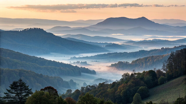 Misty mountain landscape at sunrise with layered hills and trees