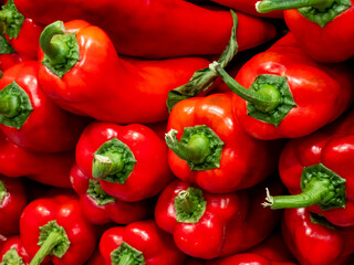 A pile of fresh red sweet peppers background