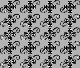 Seamless abstract floral pattern in black and white on a gray background