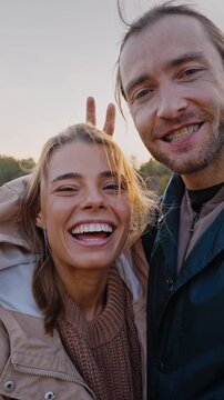 Happy couple filming real-life vlog about hiking outdoors
