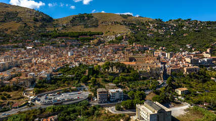 Obraz premium Aerial view of the town of Monreale, in the metropolitan city of Palermo, Sicily, Italy. It's a small town at the foot of a mountain. The cathedral in the historic center is a World Heritage Site.