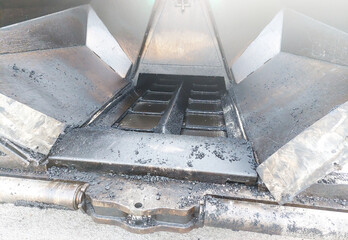 Gritty Asphalt Residue on Paving Machine Mechanism