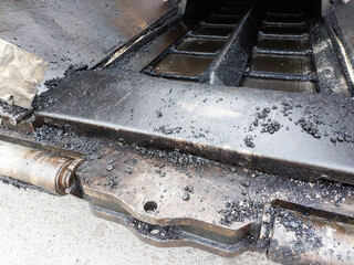 Gritty Asphalt Residue on Paving Machine Mechanism