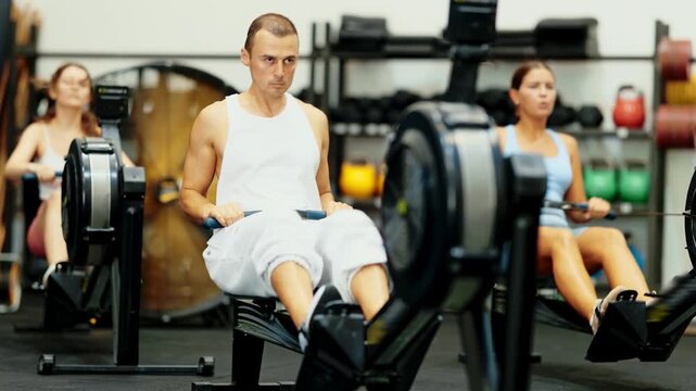 Strong sportsman training at cable row machine in modern crossfit gym. High quality 4k footage