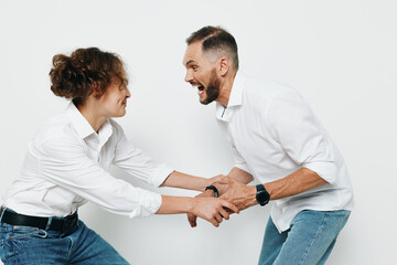 Obraz premium A professional business man and colleague share a dynamic moment against a clean colored background, expressing energy, teamwork, and motivation in a vivid workplace scene.