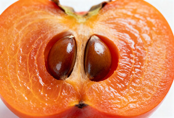 Juicy Persimmon Half with Seeds on White Background(generated by AI)