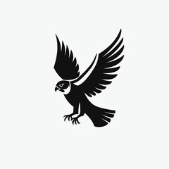 Obraz premium Dynamic black silhouette of a majestic bird of prey in flight with wings spread, symbolizing power, freedom, and strength.