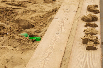 Sand molds and shovel in sandbox
