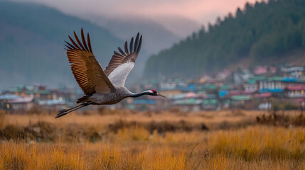 Fototapeta premium Golden fields, misty mountains, and traditional Bhutanese farmhouses below. Soft morning light illuminating the serene valley
