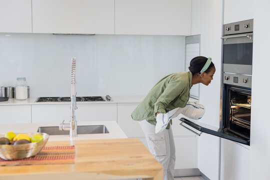 wooden island countertop featuring fruit bowl and spring coil faucet beside gas cooktop in kitchen