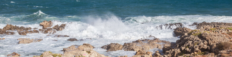 Cretan seascape in windy weather with strong surf and white foam on the sea