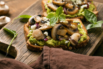 Avocado toast with sautéed mushrooms on rustic bread