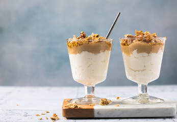 Apple caramel parfait with nuts in glass cups