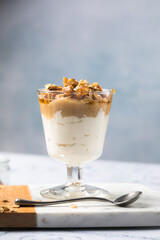 Apple caramel parfait with nuts in glass cups