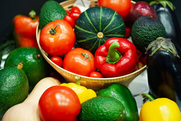 Composition with assorted raw organic vegetables (Small japanese pumpkin, Avocado, Bell peppers, Butternut Squash, Tomatoes). Detox diet. Top view.