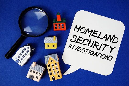 Homeland Security Investigations text with house models and magnifying glass on blue background